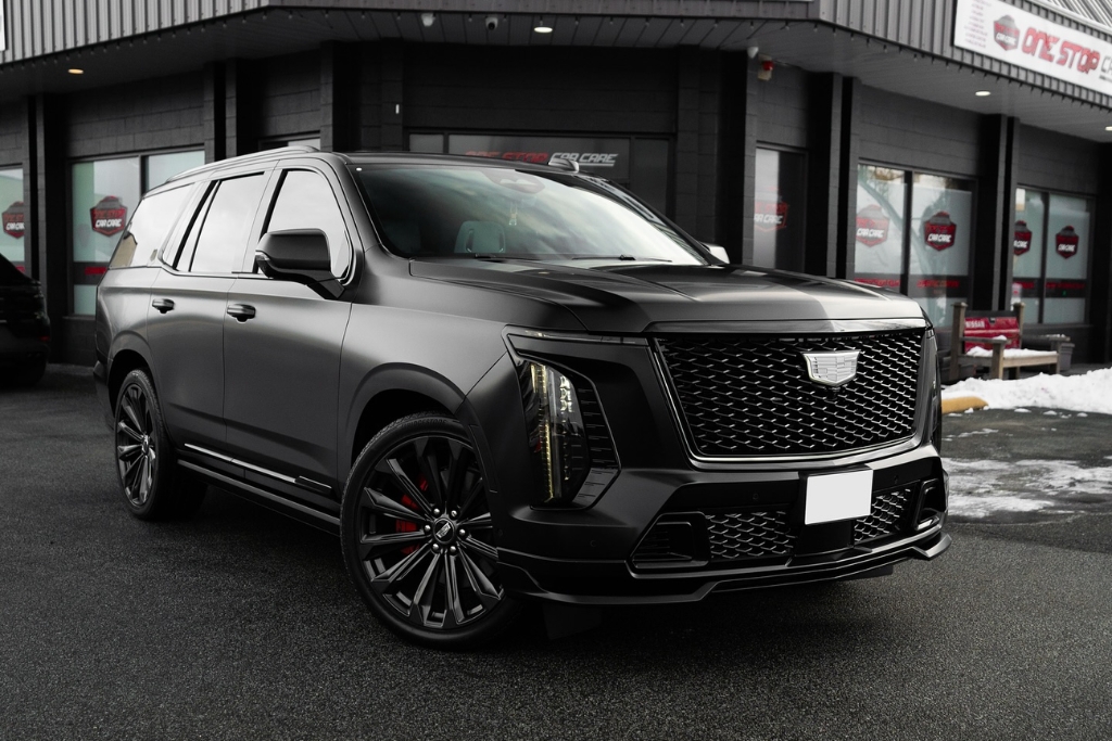 A freshly coated black Cadillac SUV parked outside a detailing shop in Surrey, BC, showcasing the sleek, high-gloss finish achieved after the Curing Process of a ceramic coating.